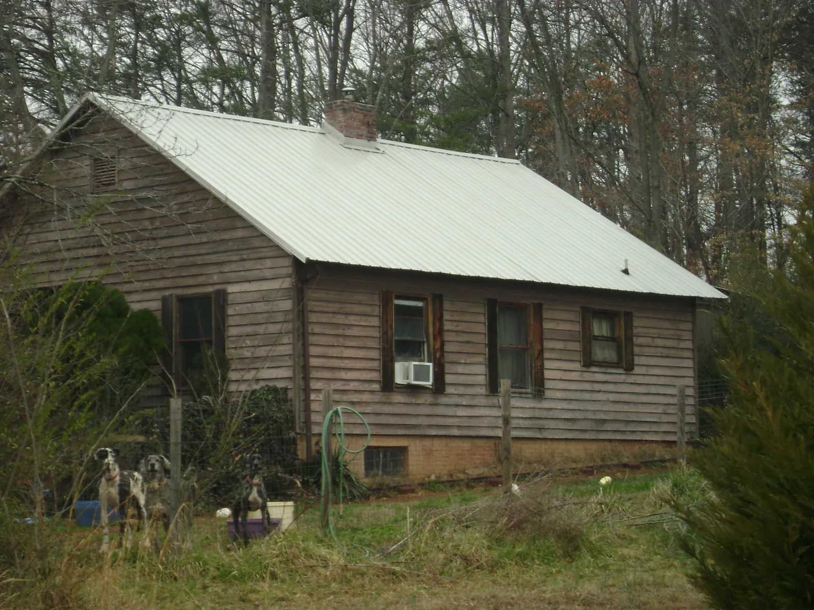 White metal roof on an old wood sided farmhouse, from a Metal Roof Installation job in South Sioux City